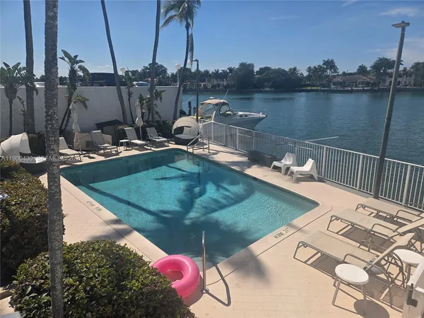 a view of a hallway with furniture and a window