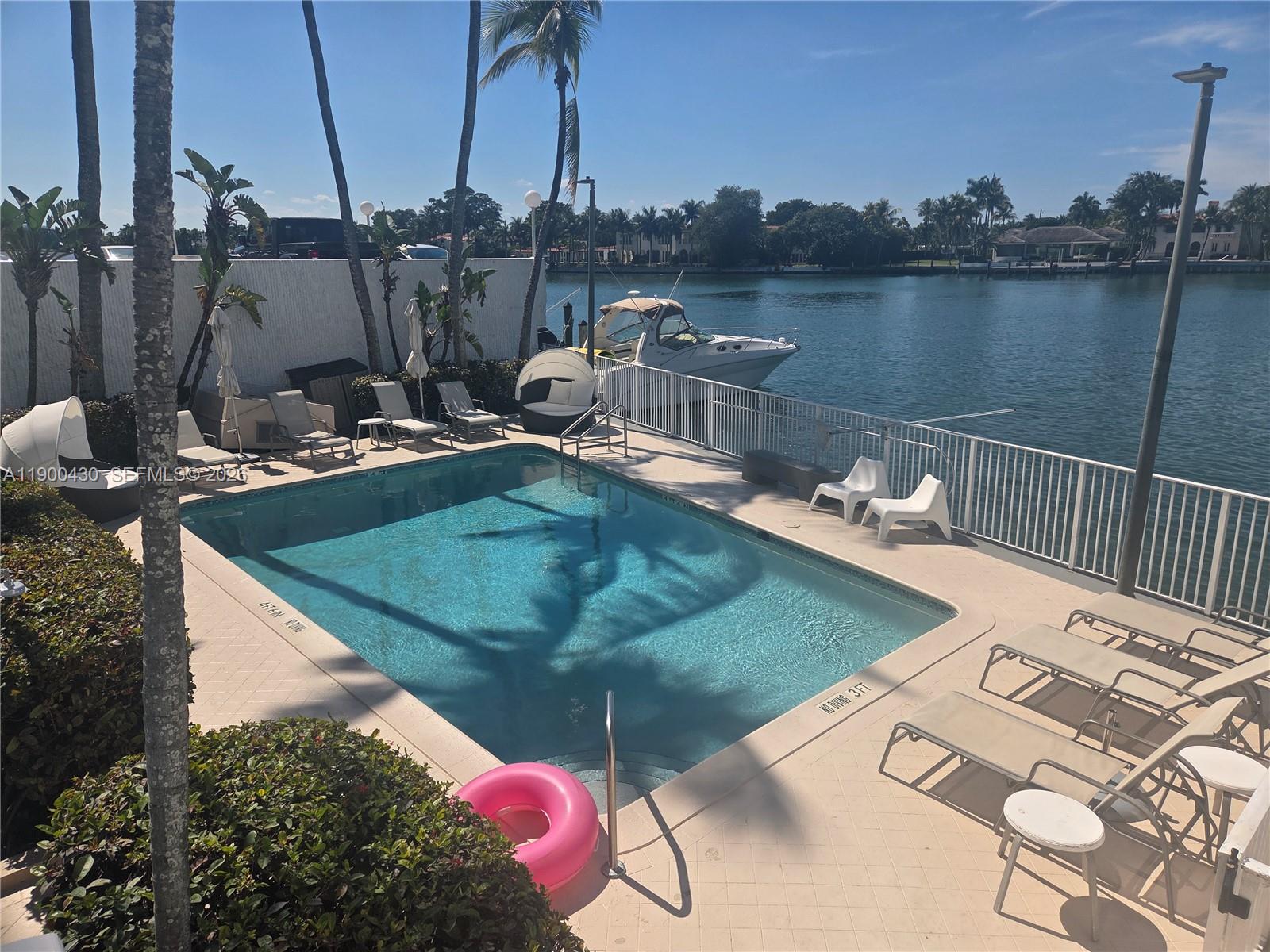 5880 Collins Avenue, Unit 806 Miami Beach, FL 33140 - Photo 20 of 30 a view of a swimming pool with a lake view
