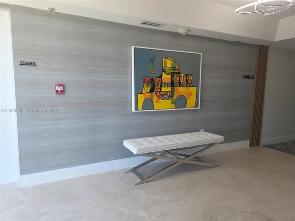 a living room with lots of furniture and a refrigerator