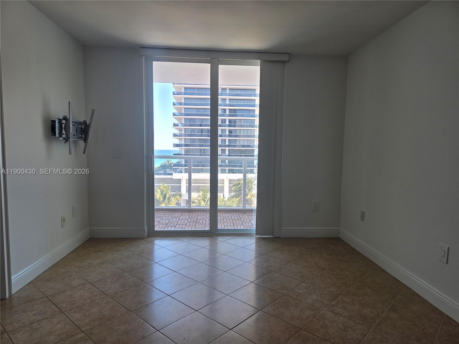 5880 Collins Avenue, Unit 806 Miami Beach, FL 33140 - Photo 3 of 30 a view of an empty room with a window