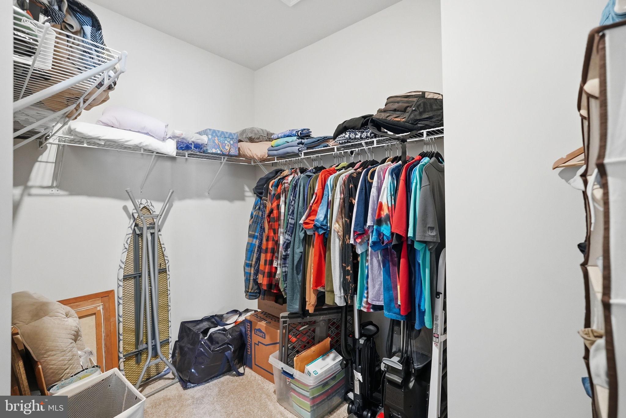 9365 Barnes Loop Manassas, VA 20110 - Photo 14 of 37 a view of walk in closet with clothes and shoes