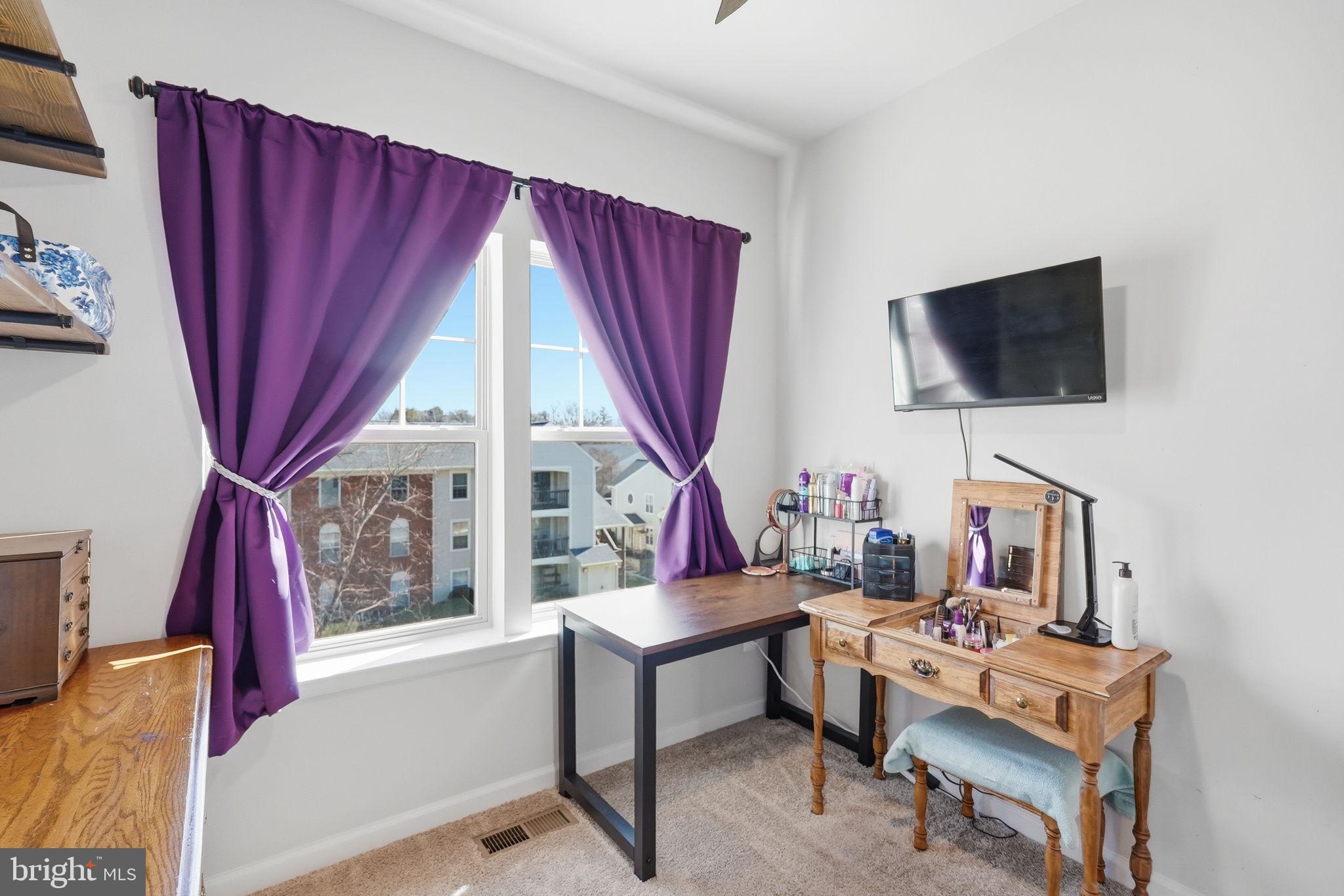 9365 Barnes Loop Manassas, VA 20110 - Photo 17 of 37 a living room with furniture a flat screen tv and a large window