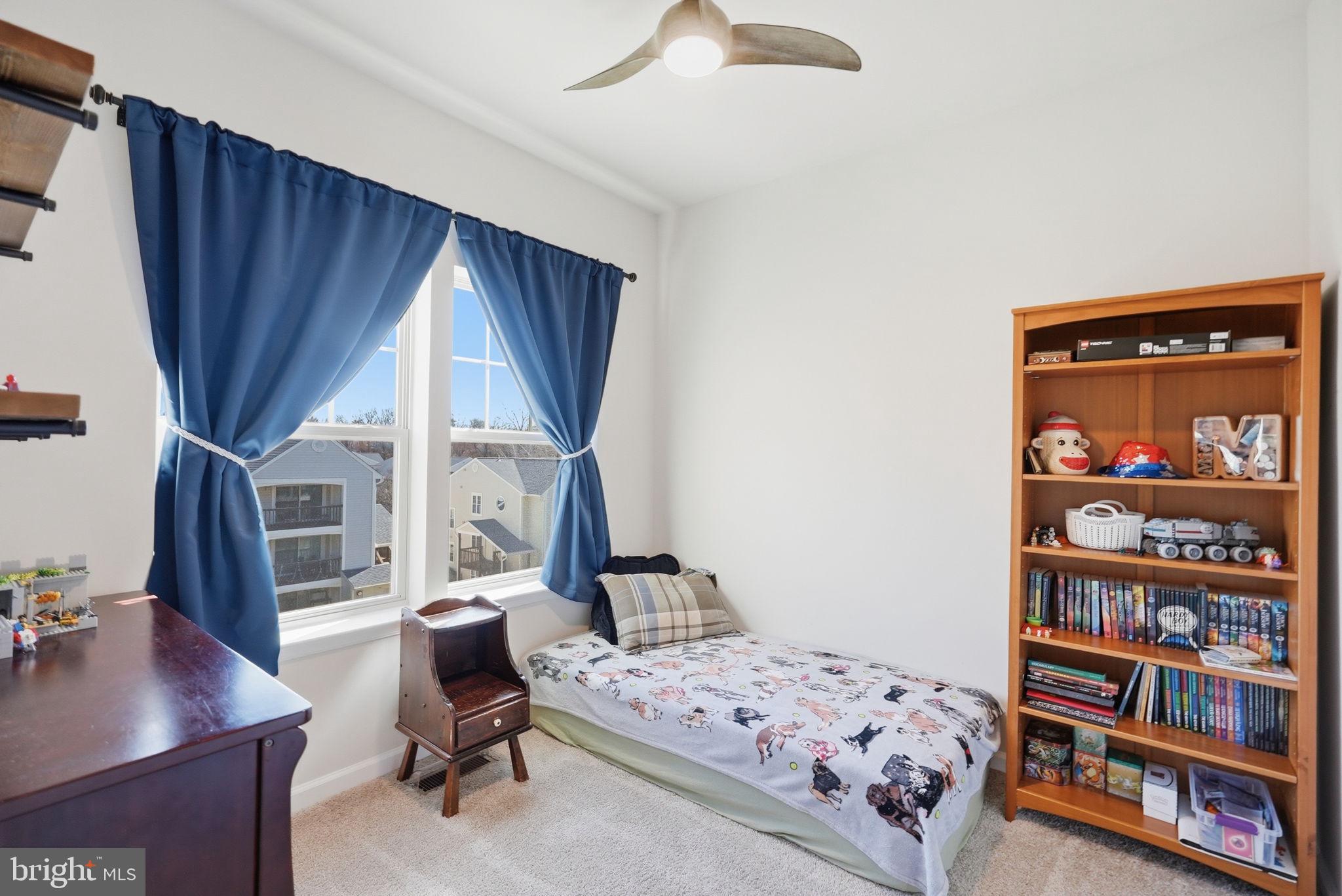 9365 Barnes Loop Manassas, VA 20110 - Photo 19 of 37 a bedroom with a bed cabinets and a window
