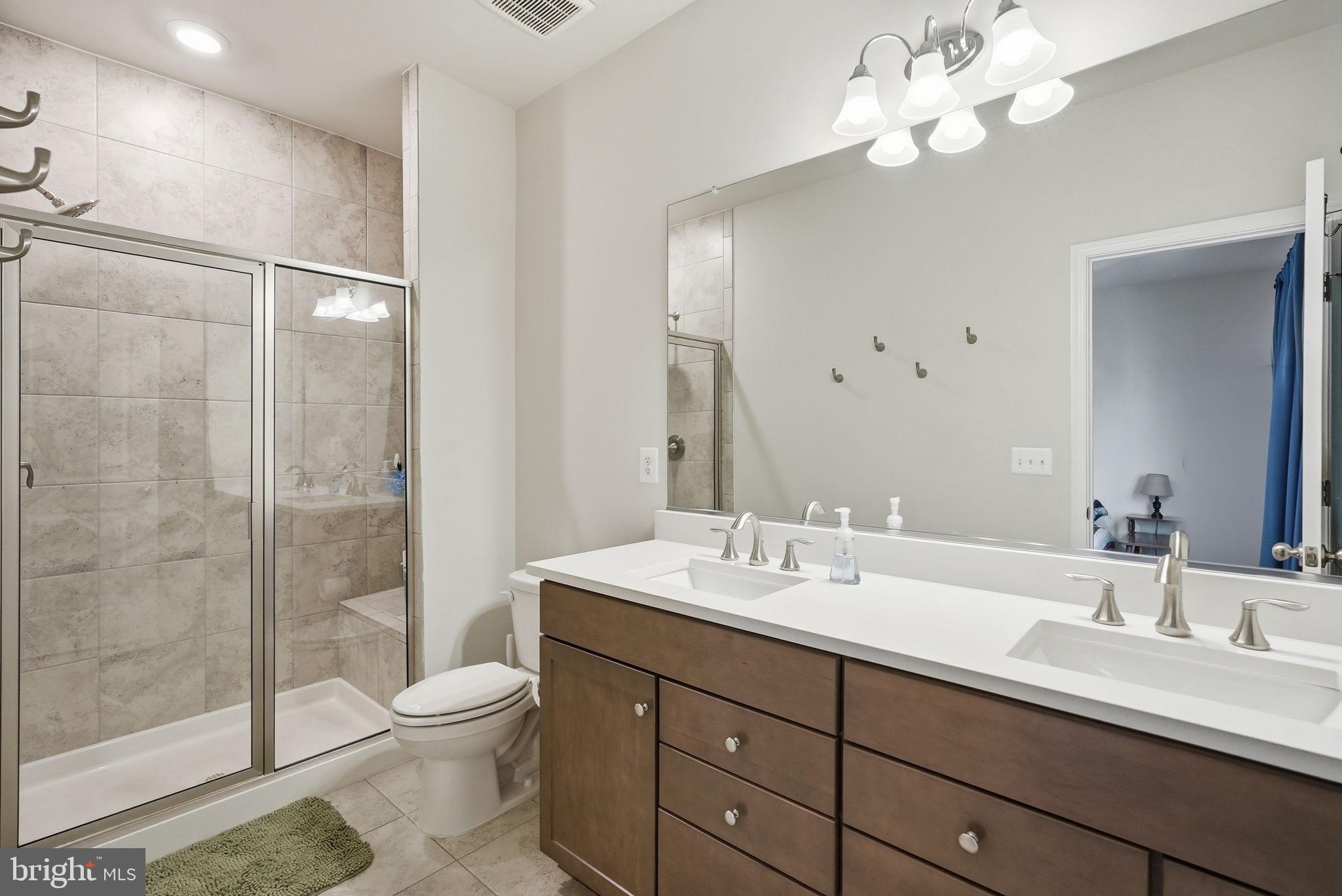 9365 Barnes Loop Manassas, VA 20110 - Photo 22 of 37 a bathroom with a double vanity sink mirror and toilet