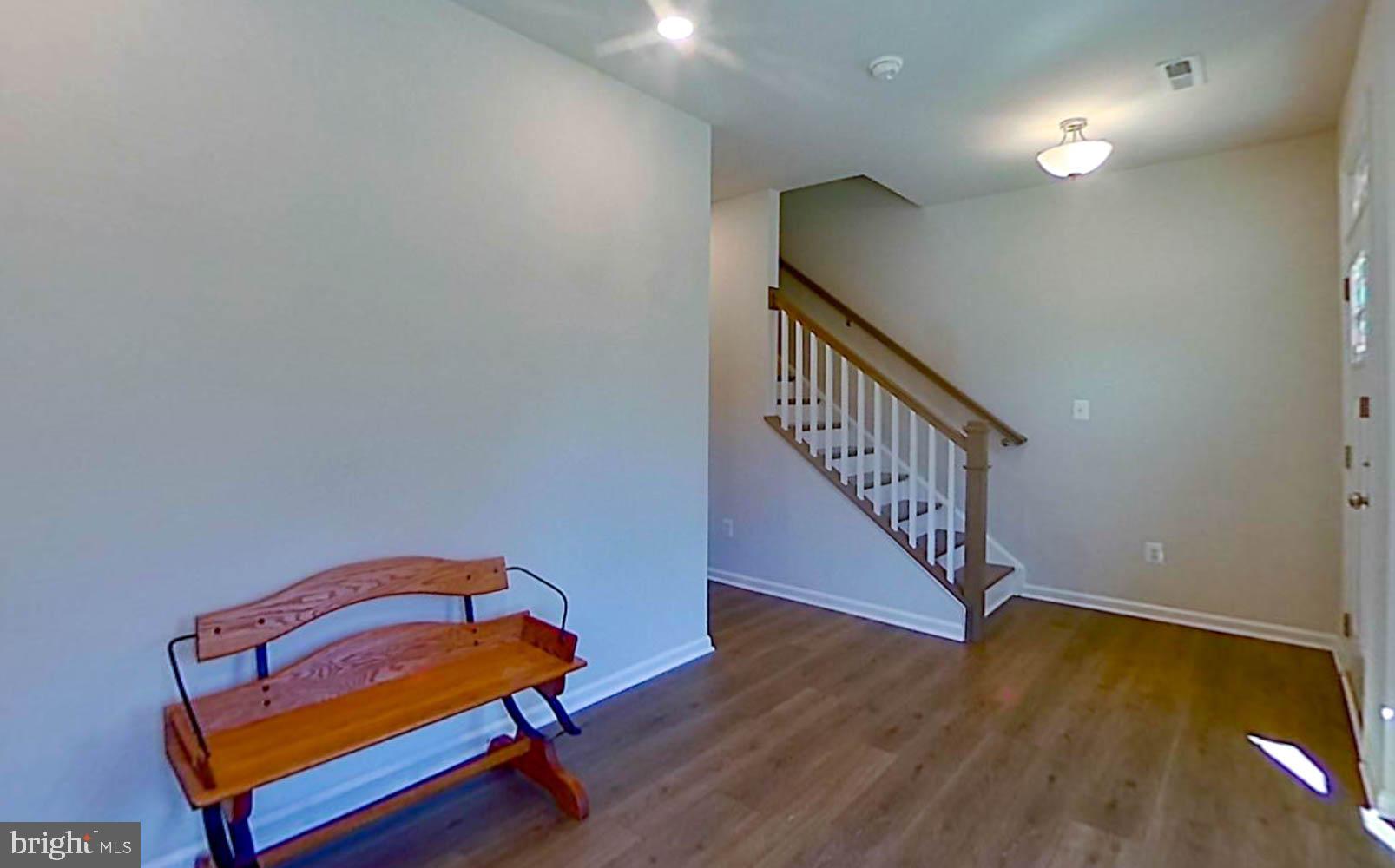 9365 Barnes Loop Manassas, VA 20110 - Photo 28 of 37 a room with stairs and wooden floor
