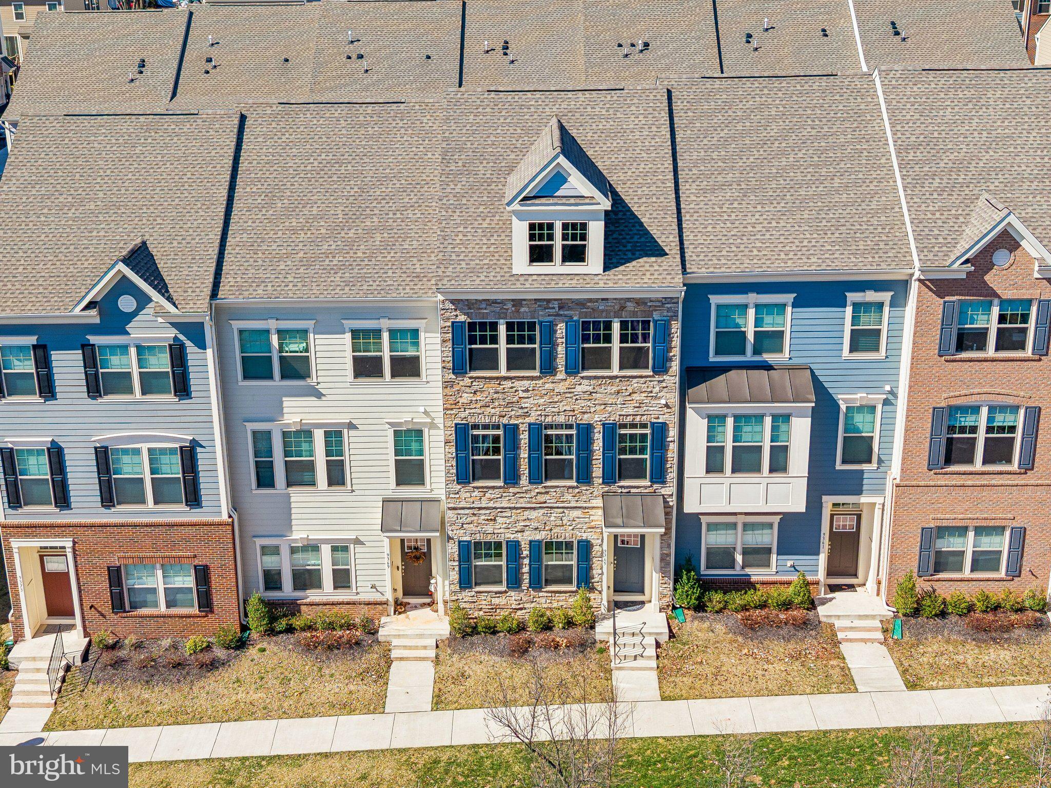9365 Barnes Loop Manassas, VA 20110 - Photo 31 of 37 a front view of a residential apartment building with a yard