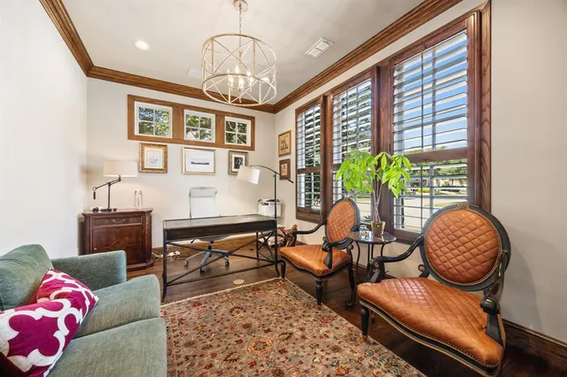 a living room with furniture chandelier and window
