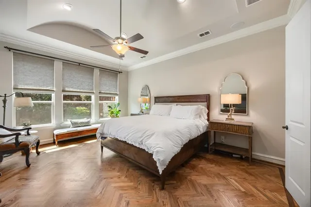 a bedroom with a bed and a large window with the outer view