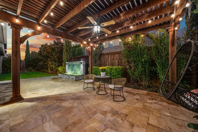 a view of a porch with furniture and a yard