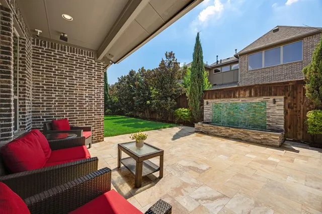 a backyard of a house with yard table and chairs