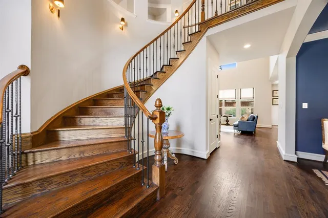 a view of staircase and living room with wooden floor