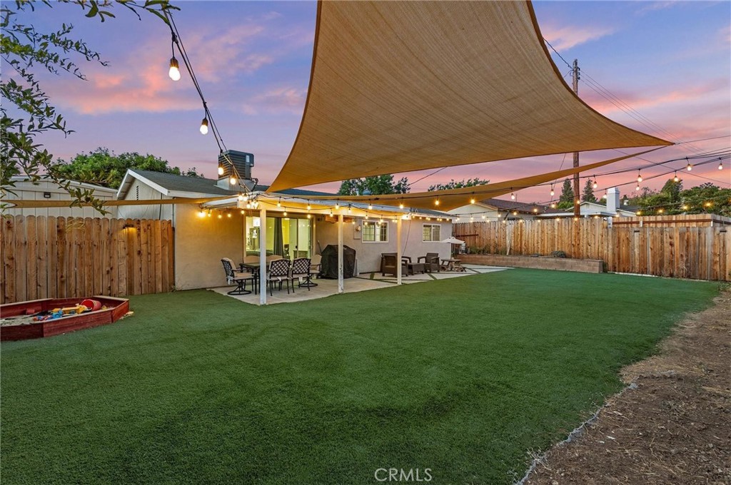 549 Appleton Road Simi Valley, CA 93065 - Photo 1 of 1 a view of a patio with table and chairs under an umbrella