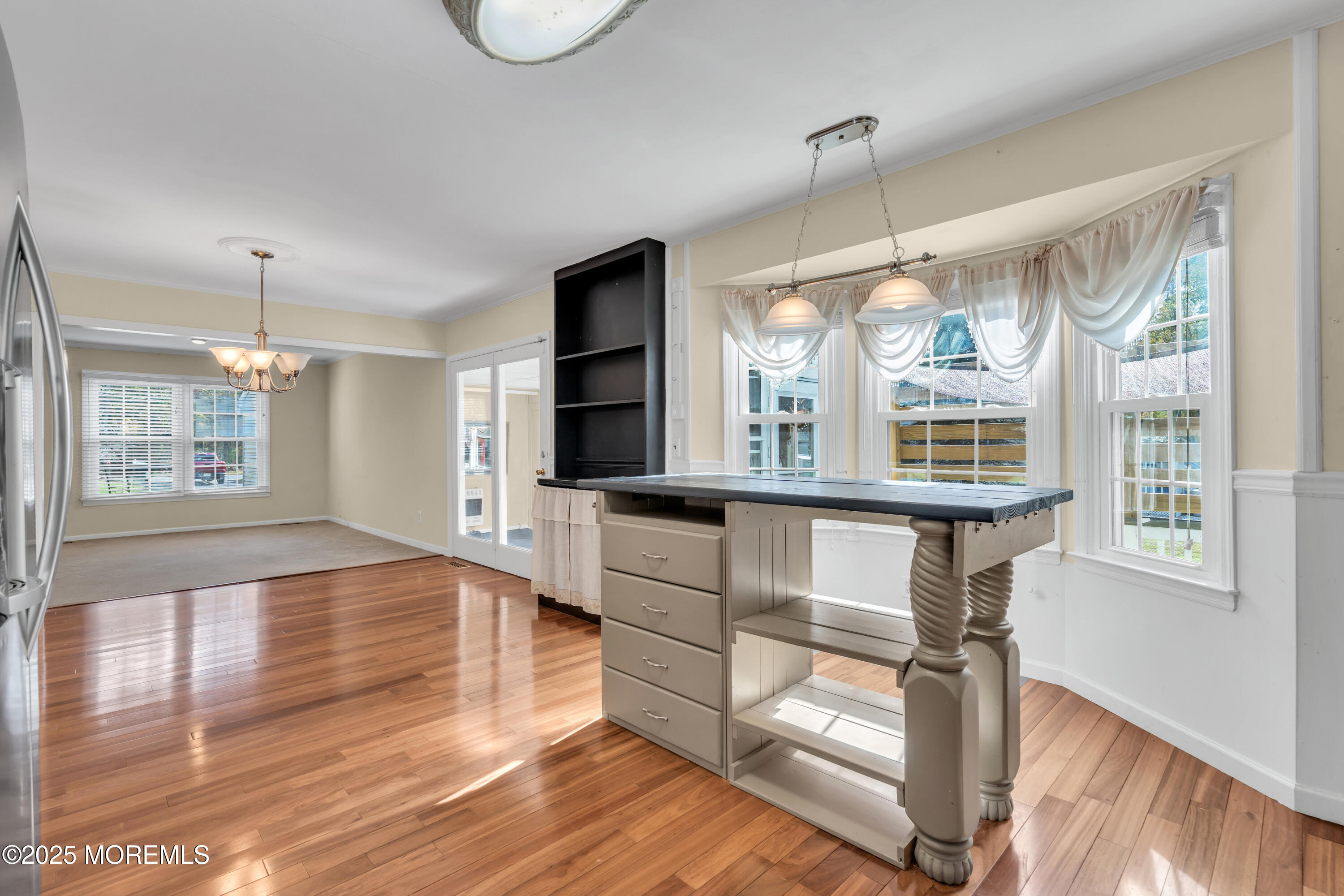 638 Freehold Road Jackson, NJ 08527 - Photo 14 of 61 a view of an empty room with wooden floor and a window