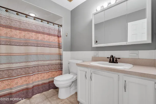 a bathroom with a sink toilet and vanity