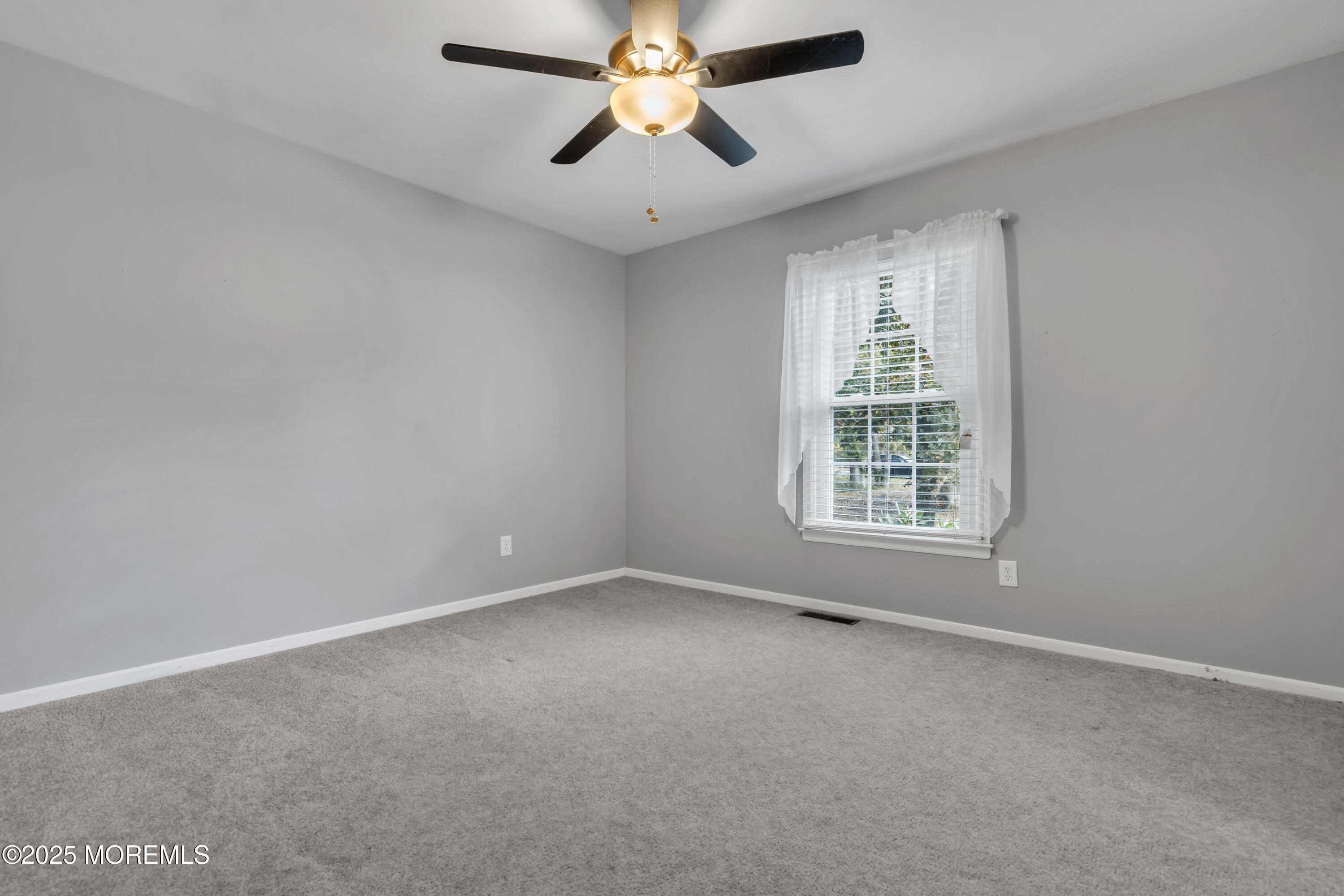 638 Freehold Road Jackson, NJ 08527 - Photo 16 of 61 an empty room with chandelier fan and windows