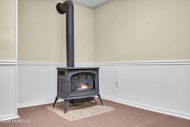 a view of backyard with wooden fence and a large tree