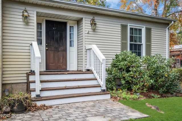 a front view of a house with a garden