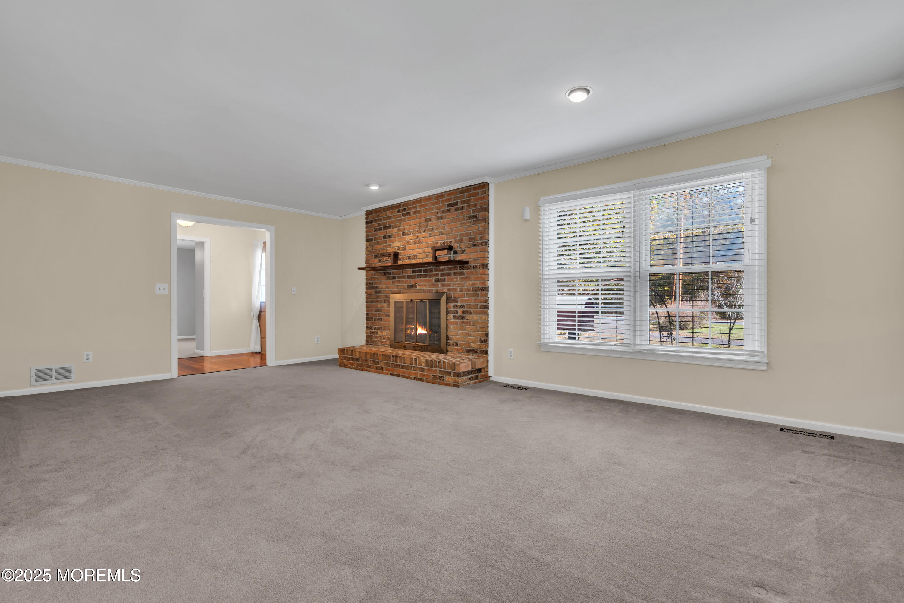 638 Freehold Road Jackson, NJ 08527 - Photo 43 of 61 a view of an empty room with a window and fireplace