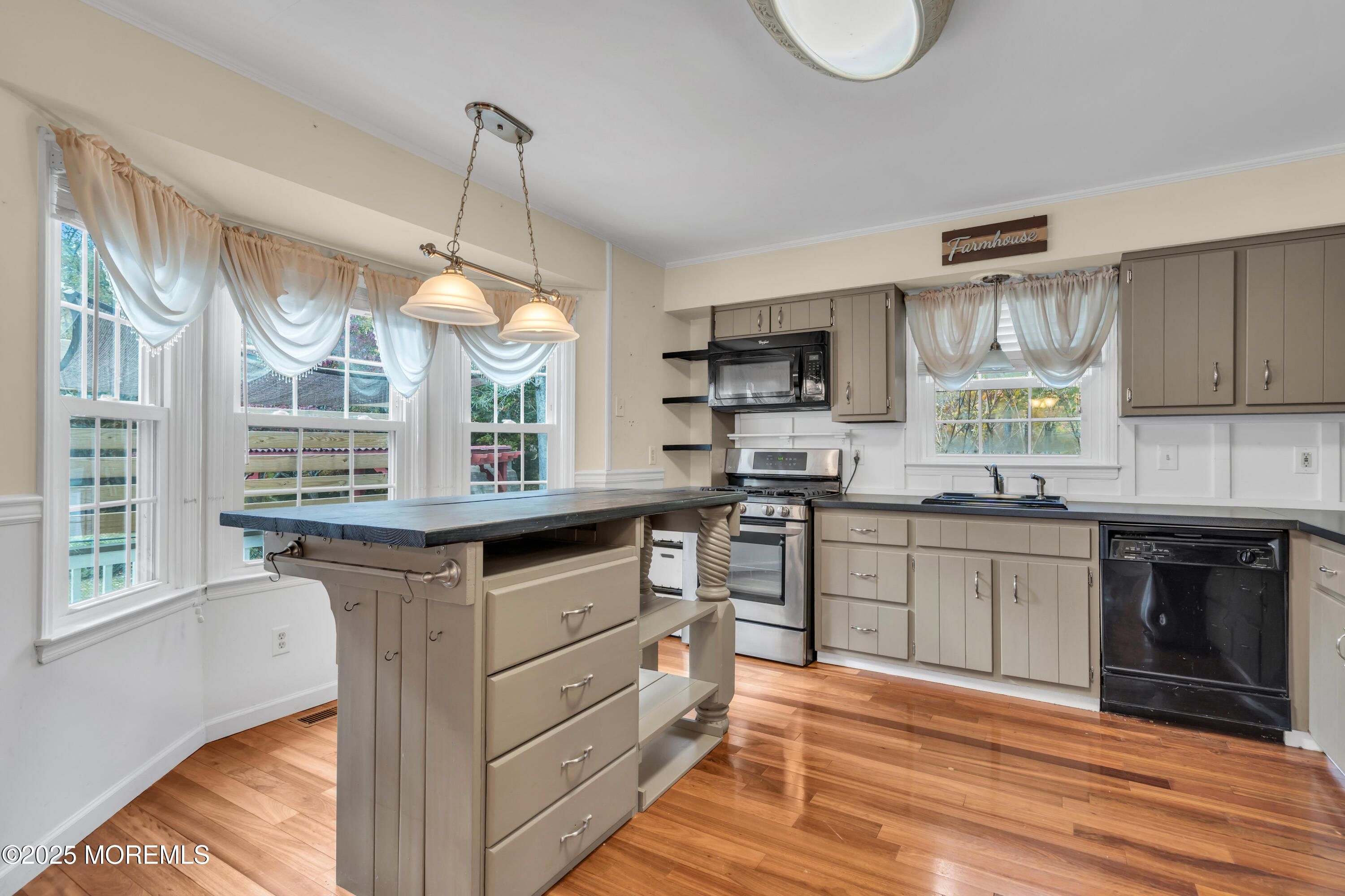 638 Freehold Road Jackson, NJ 08527 - Photo 46 of 61 a kitchen with granite countertop a stove cabinets and wooden floor