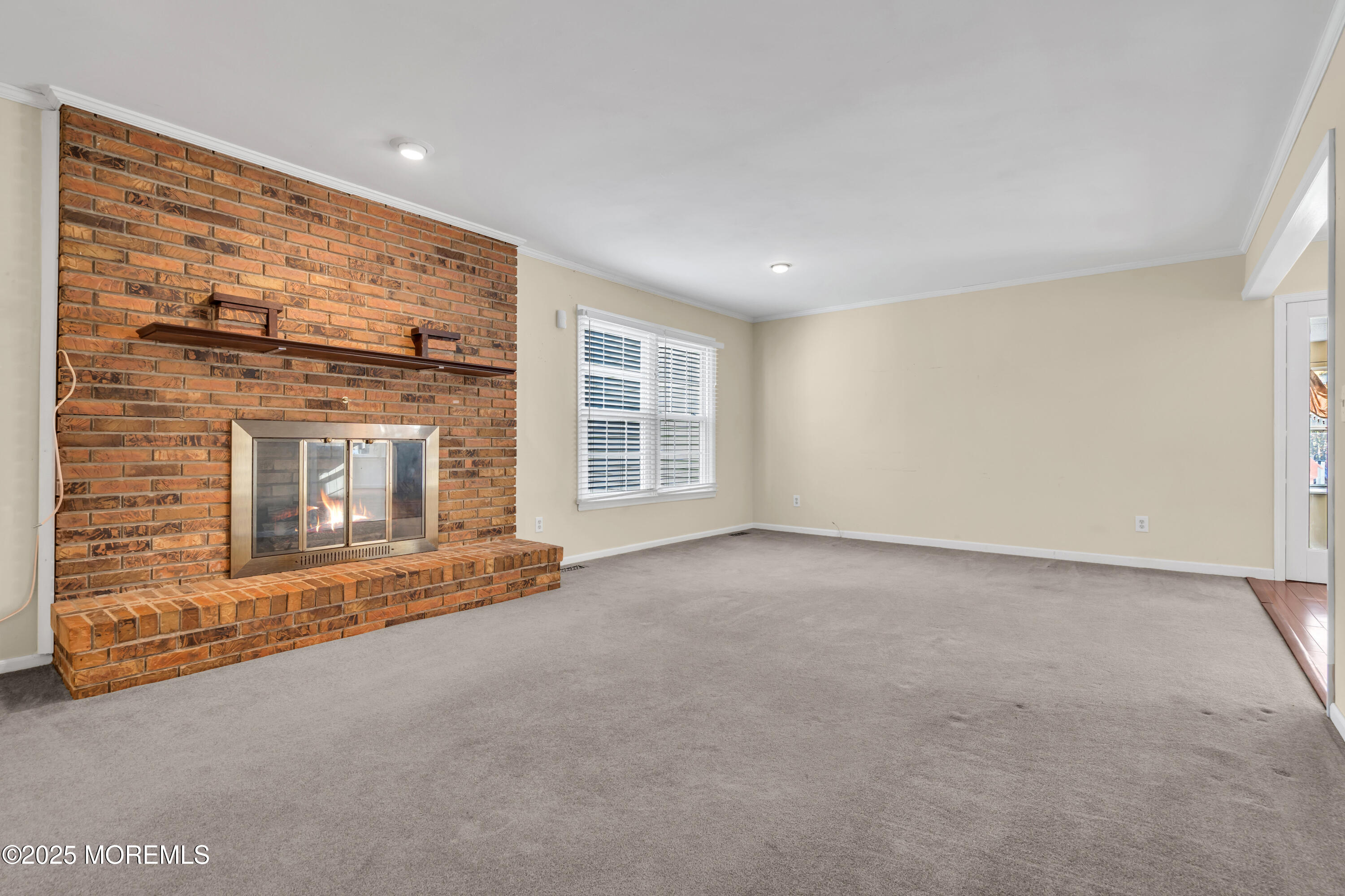 638 Freehold Road Jackson, NJ 08527 - Photo 5 of 61 a view of an empty room with a fireplace and a window