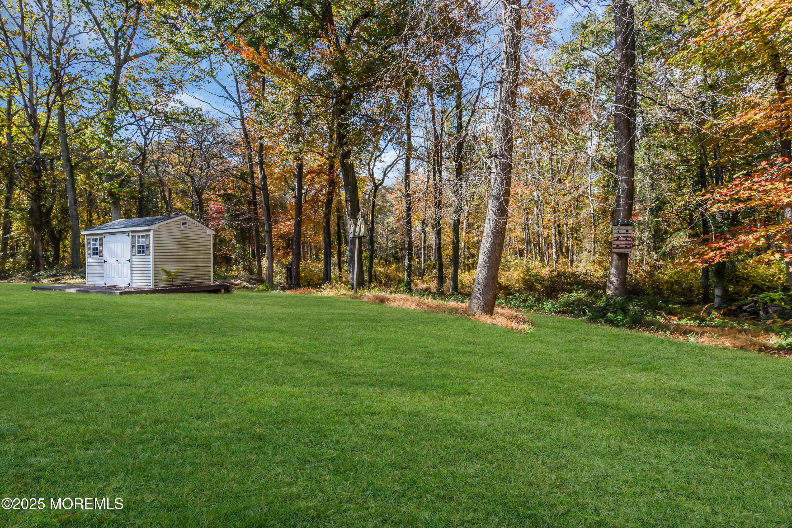 638 Freehold Road Jackson, NJ 08527 - Photo 55 of 61 a view of a white house with a big yard and large trees