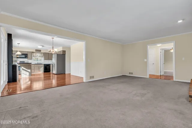 an empty room with a kitchen and a sink