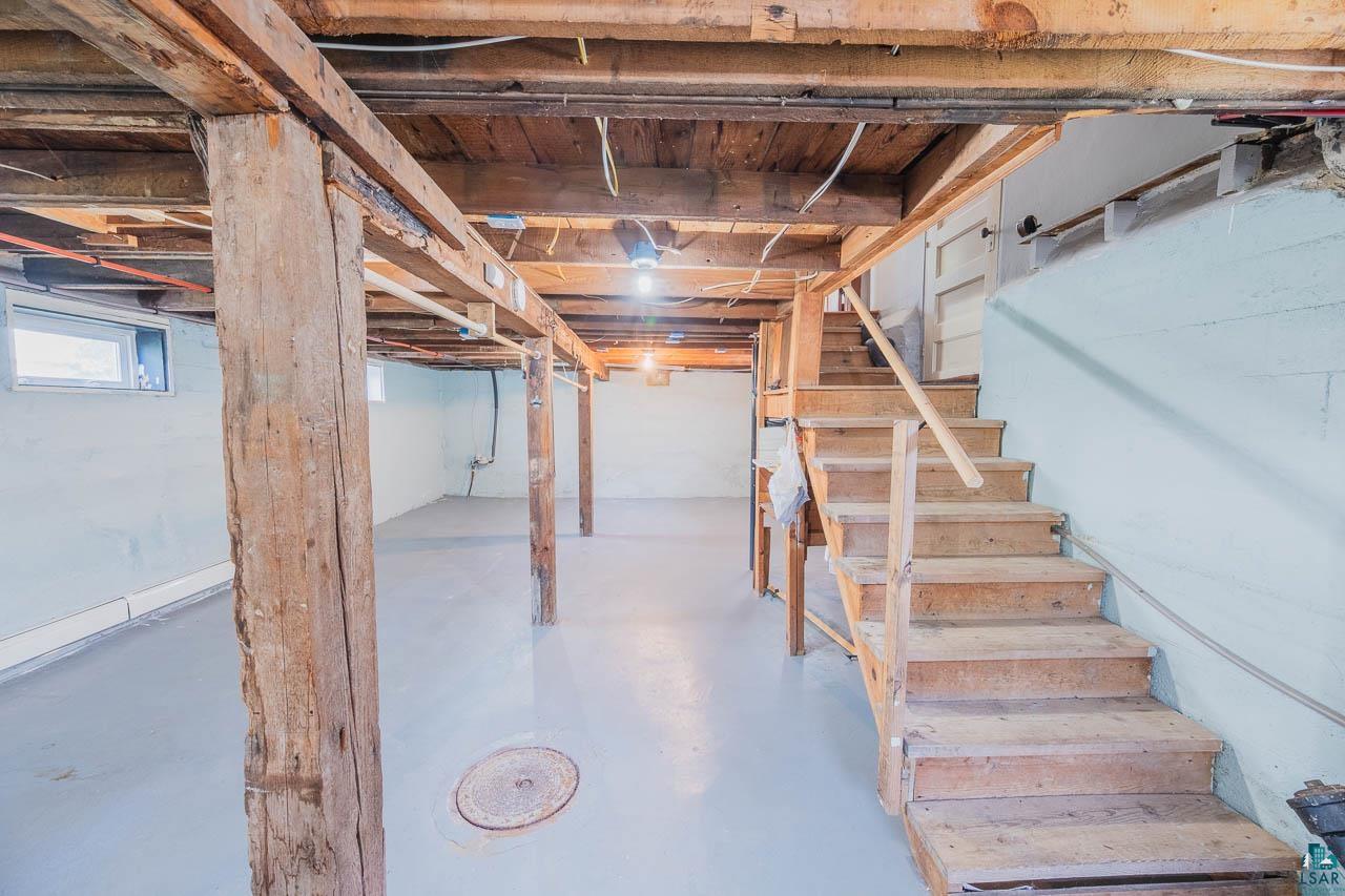 508 10th Street South Virginia, MN 55792 - Photo 28 of 43 Spacious unfinished basement featuring exposed wood beams and posts, concrete flooring, and a window