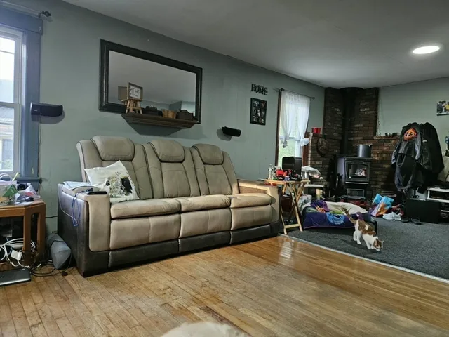 a living room with furniture a window and a flat screen tv