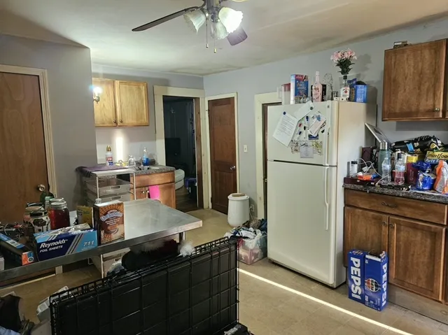 a kitchen with refrigerator and cabinets