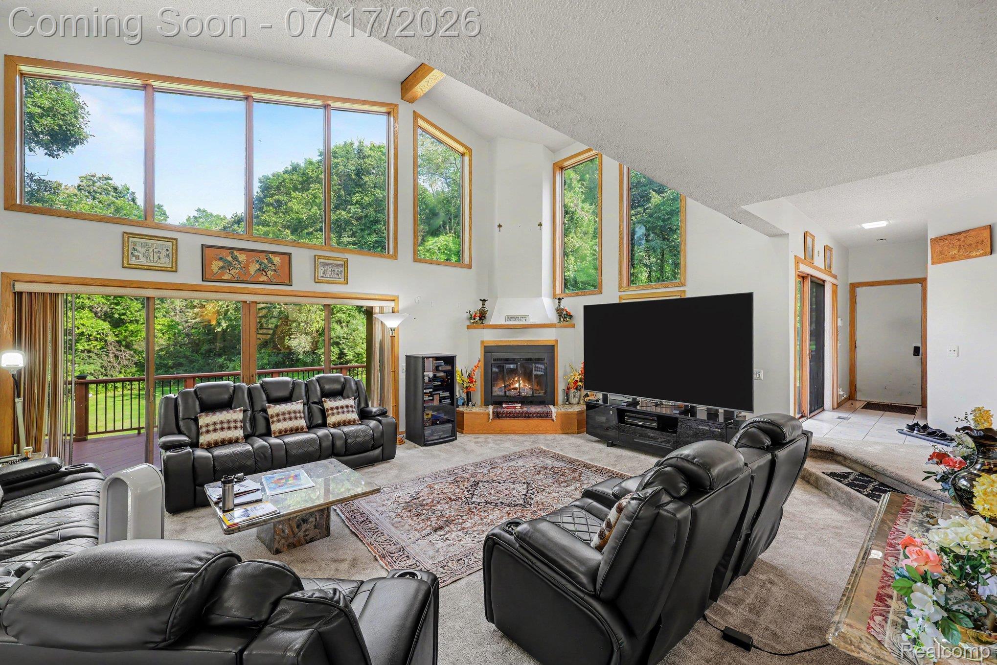 5685 Paint Valley Drive Rochester, MI 48306 - Photo 9 of 66 Spacious living area featuring a vaulted ceiling and an expansive window wall