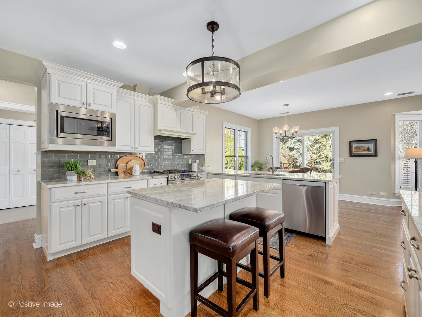 207 Ravine Road Hinsdale, IL 60521 - Photo 9 of 35 a kitchen with white cabinets and stainless steel appliances