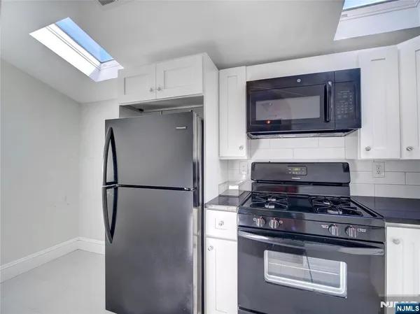 a kitchen with cabinets and stainless steel appliances