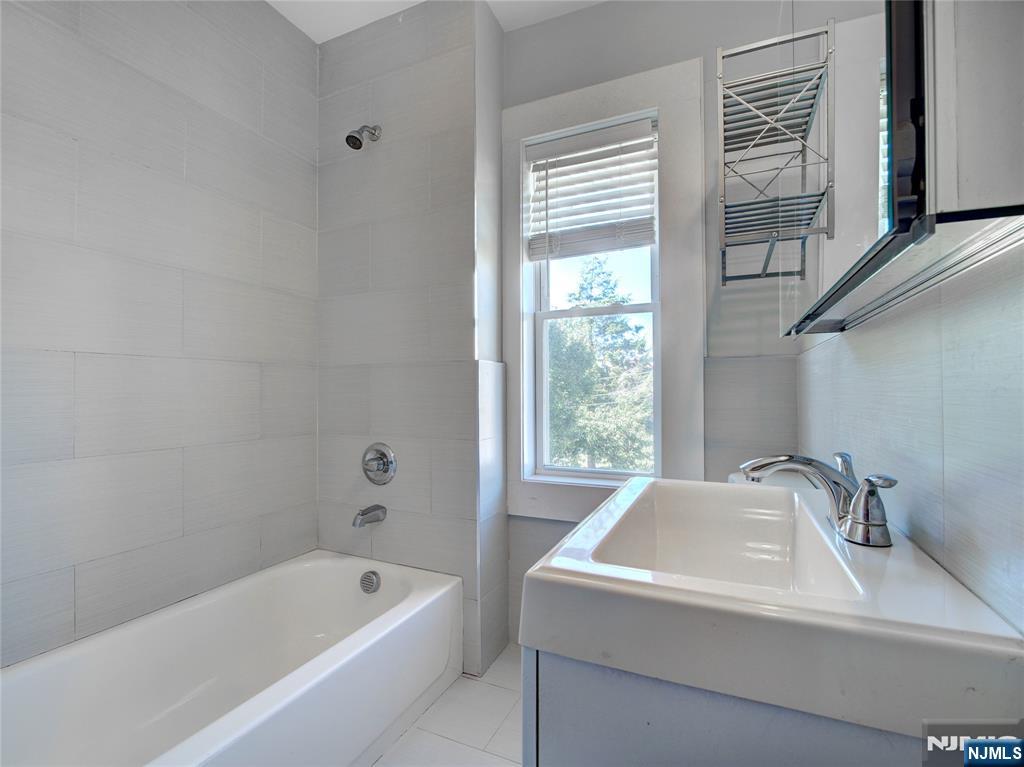 222 Lafayette Avenue, Unit 2 Lyndhurst, NJ 07071 - Photo 10 of 15 a bathroom with a sink and a bathtub