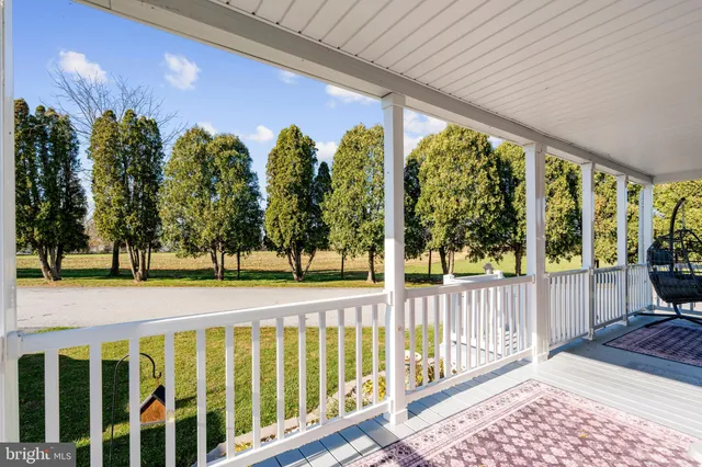 a view of a porch with wooden floor and outdoor space