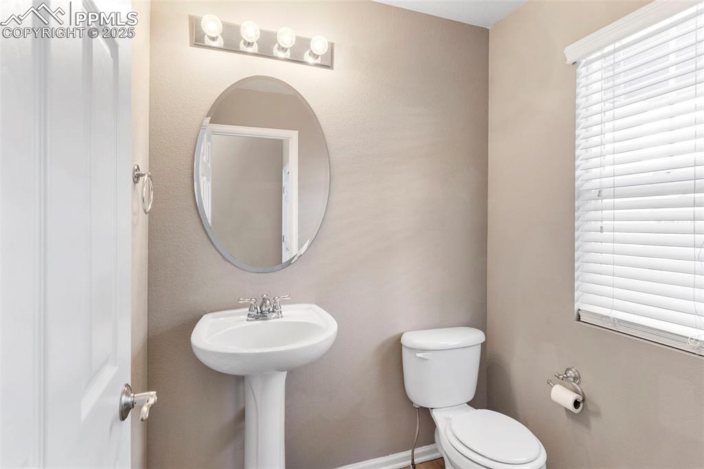 7710 Sistine Lane Fountain, CO 80817 - Photo 14 of 33 a bathroom with a toilet sink and mirror
