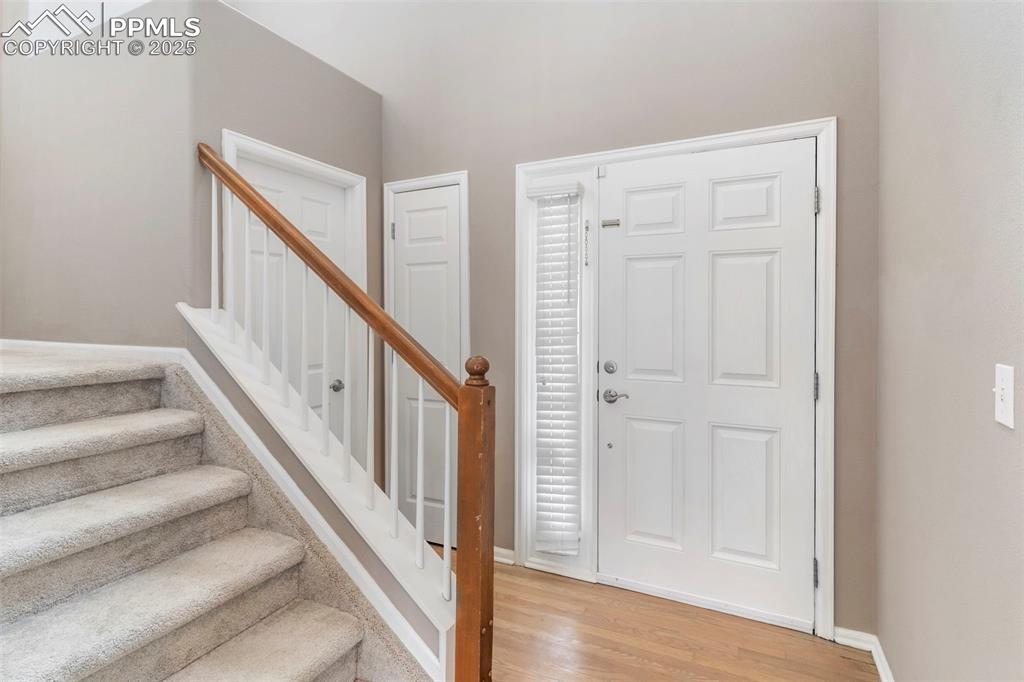 7710 Sistine Lane Fountain, CO 80817 - Photo 15 of 33 a view of staircase with wooden floor and white walls