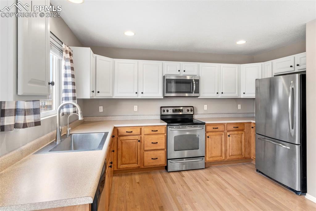 7710 Sistine Lane Fountain, CO 80817 - Photo 6 of 33 a kitchen with stainless steel appliances granite countertop a refrigerator sink and stove