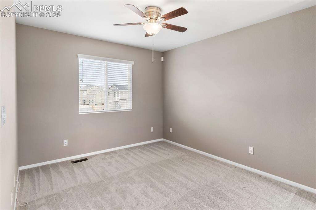 7710 Sistine Lane Fountain, CO 80817 - Photo 8 of 33 an empty room with windows and fan