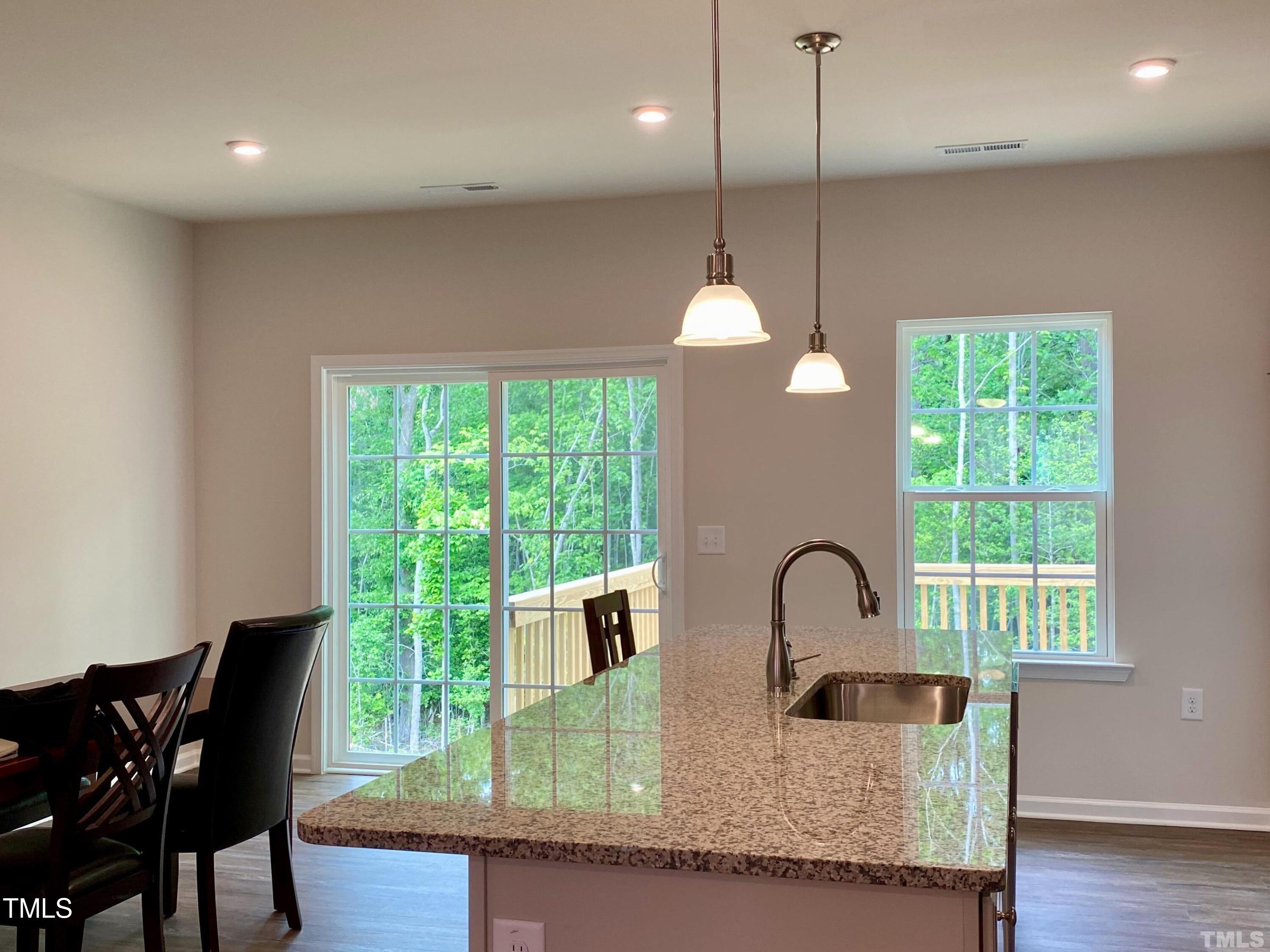 6627 Pathfinder Way Raleigh, NC 27616 - Photo 12 of 35 a kitchen with granite countertop a window and a sink