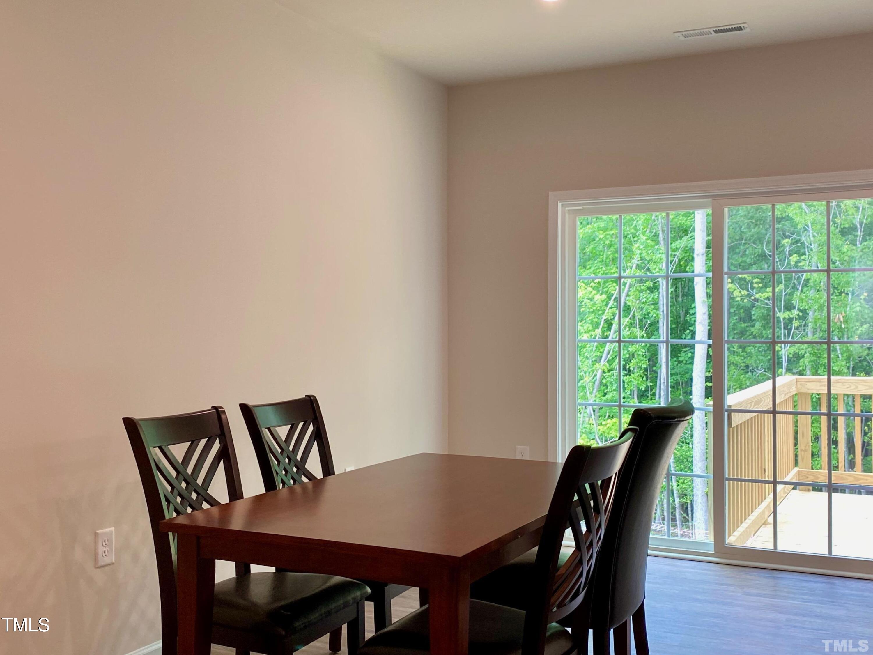 6627 Pathfinder Way Raleigh, NC 27616 - Photo 14 of 35 a view of a dining room with furniture window and wooden floor