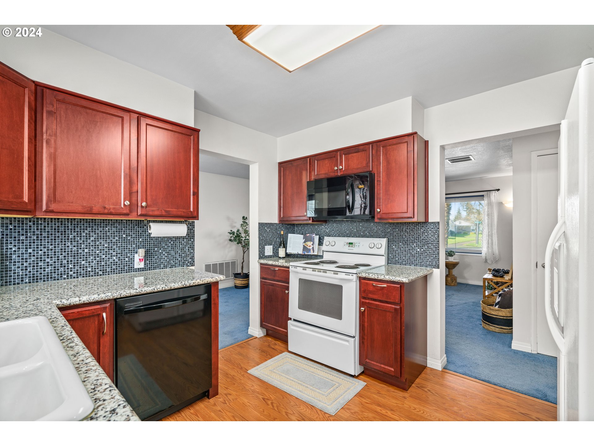 1841 Market Street Springfield, OR 97477 - Photo 9 of 23 a kitchen with stainless steel appliances granite countertop a stove top oven a sink dishwasher and a microwave oven with cabinets