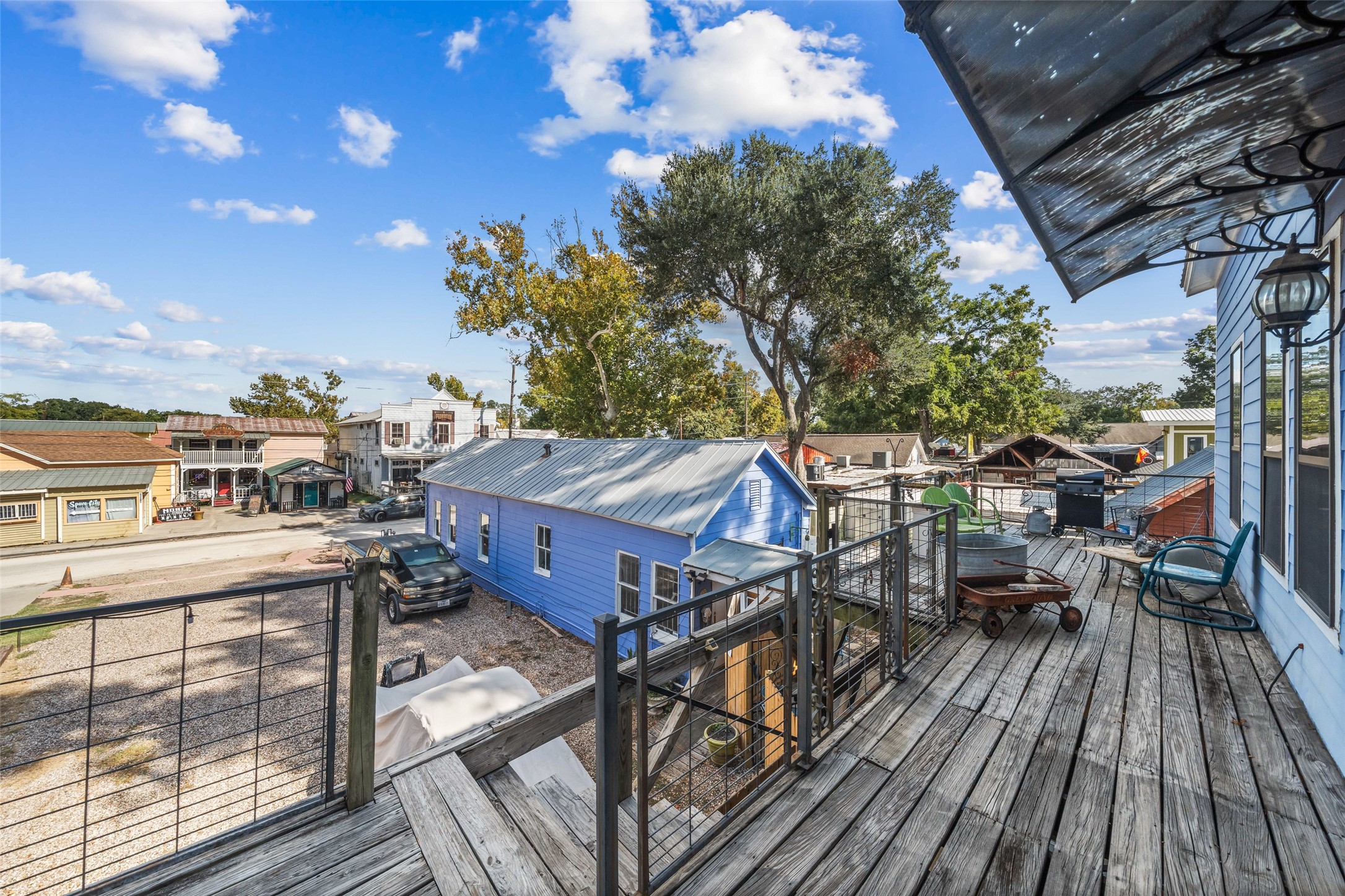 26407 Preston Avenue Spring, TX 77373 - Photo 15 of 38 a view of a roof deck with table and chairs a barbeque with wooden floor and fence