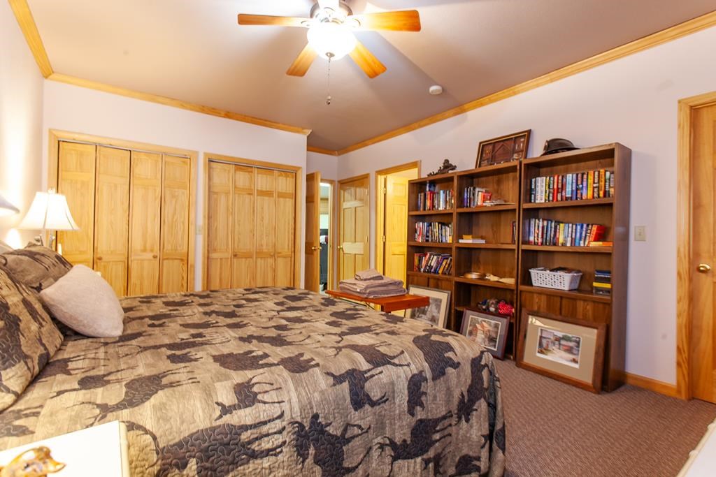 164 Freedom Pass Drive Murphy, NC 28906 - Photo 33 of 65 a bedroom with a large bed and a chandelier