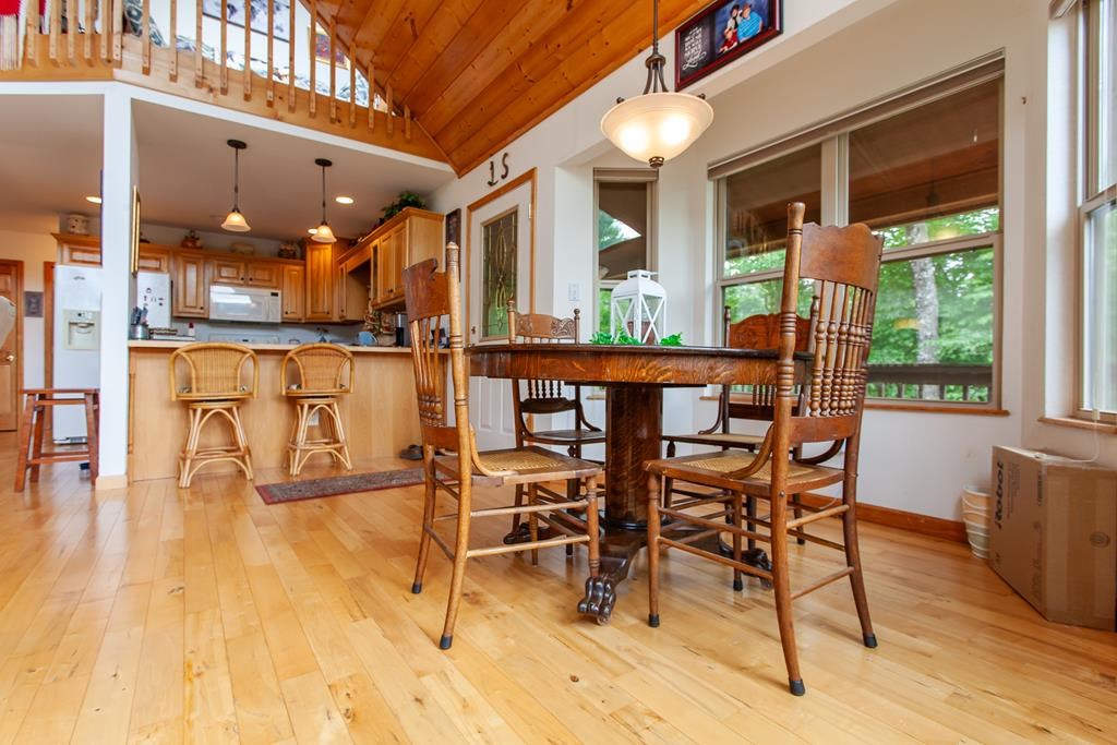 164 Freedom Pass Drive Murphy, NC 28906 - Photo 57 of 65 a dining room with furniture a chandelier and wooden floor