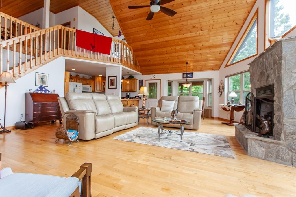 164 Freedom Pass Drive Murphy, NC 28906 - Photo 61 of 65 a living room with furniture a fireplace and a large window