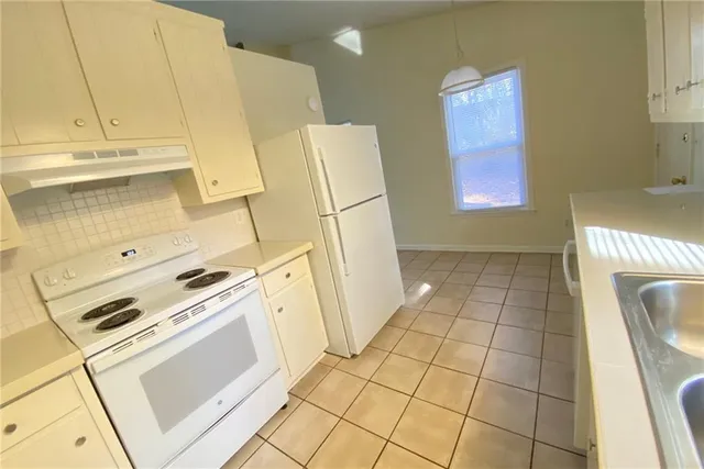 a view of empty room with wooden floor and fireplace