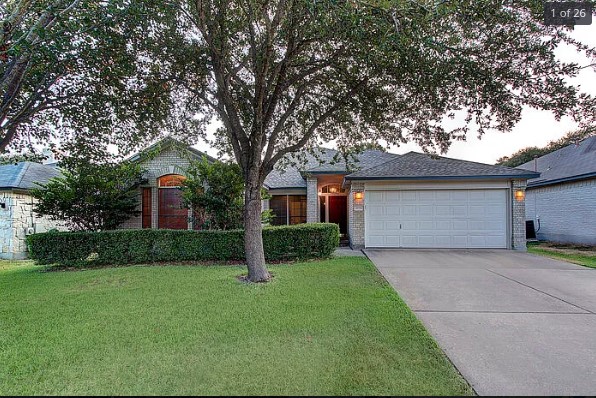a front view of house with yard and green space