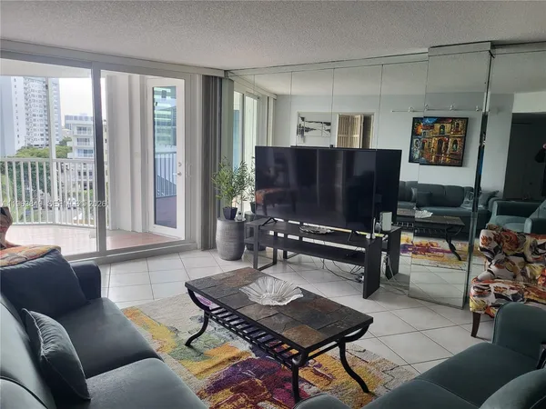 a living room with furniture and a piano