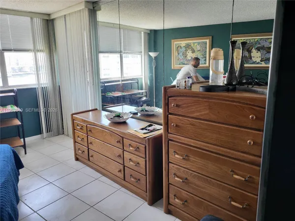 a kitchen with a stove cabinets and wooden floor