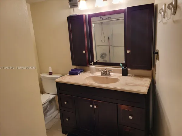 a bathroom with a sink vanity and a mirror